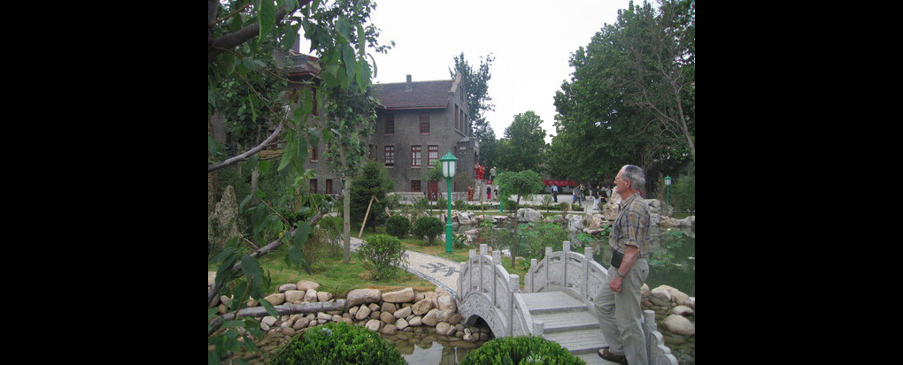 'August 2005. The picturesque miniature bridge from Ledao Square ('Happy Way Square') to the former Shadyside Hospital, Block 61. This bridge is located approximately where the guard tower overlooking the hospital 'park' used to be. What a delightful irony: no longer 'Confinement Tower', but 'Liberty Bridge', leading to the freedom of Ledao Square and the Wall of Remembrance!