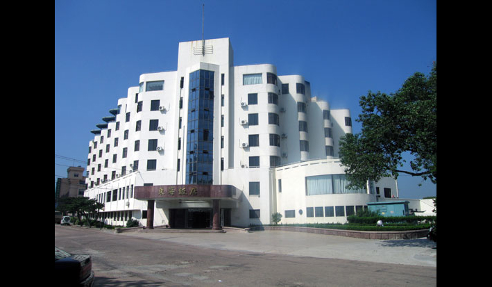 'August 2005. Former Edgewater Mansions Hotel, front view. Now known as Donghai Fandian (East Sea Hotel), it is for the exclusive use of Chinese military personnel on vacation. You can't gain access now - even to look around the foyer. 